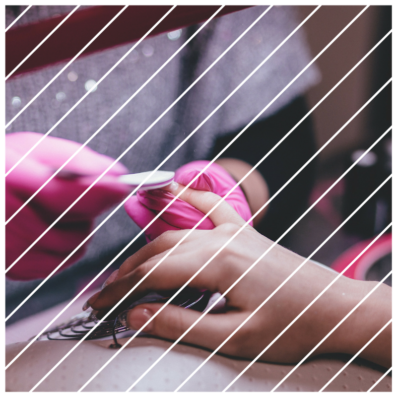 Woman getting nails done in nail salon